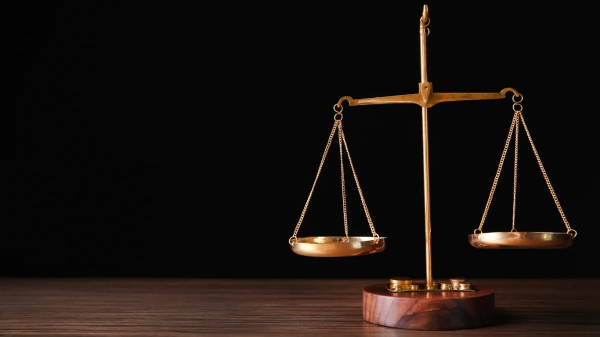 Brass justice scales on a desk, representing the court record TheRecordXchange manages.