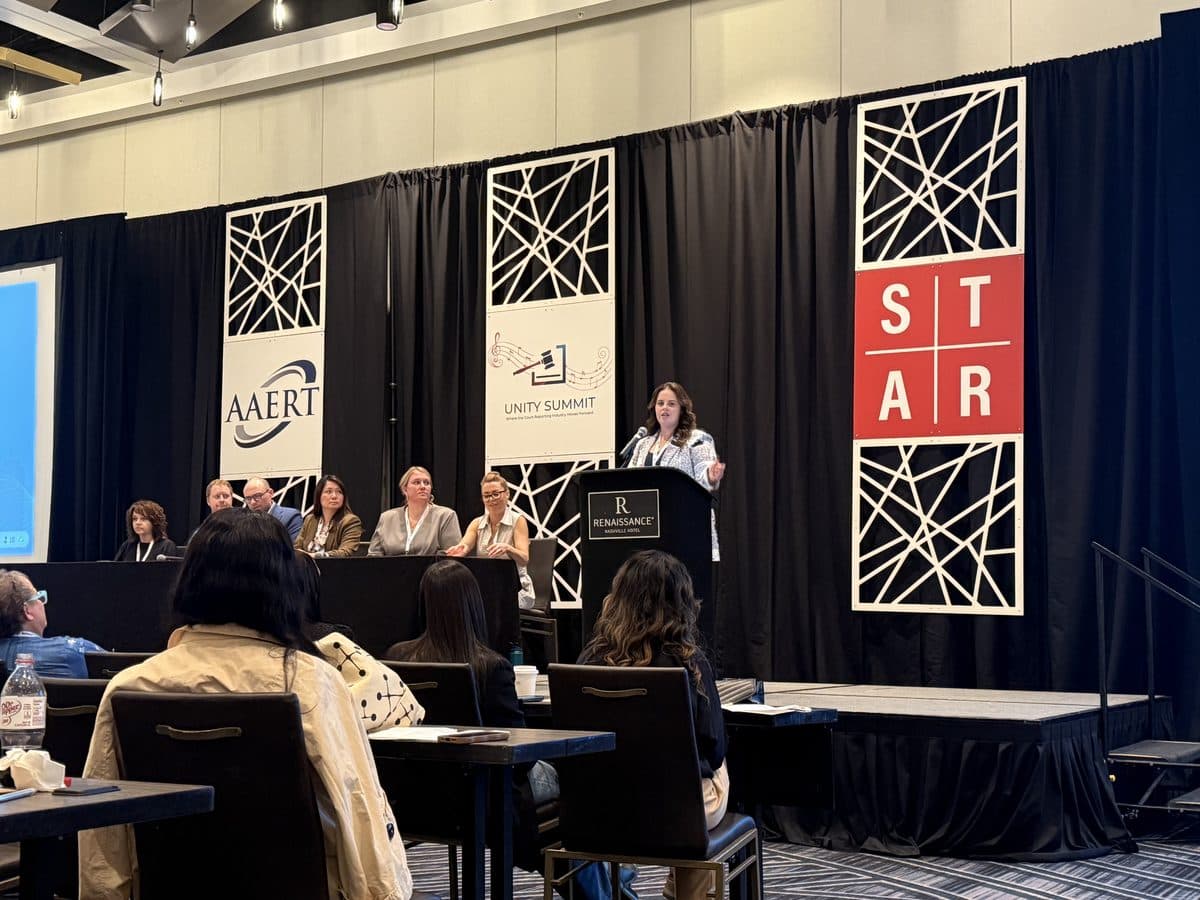 Panel session at the AAERT Unity Summit, Nashville — speaker at the podium with AAERT, Unity Summit, and STAR banners on stage